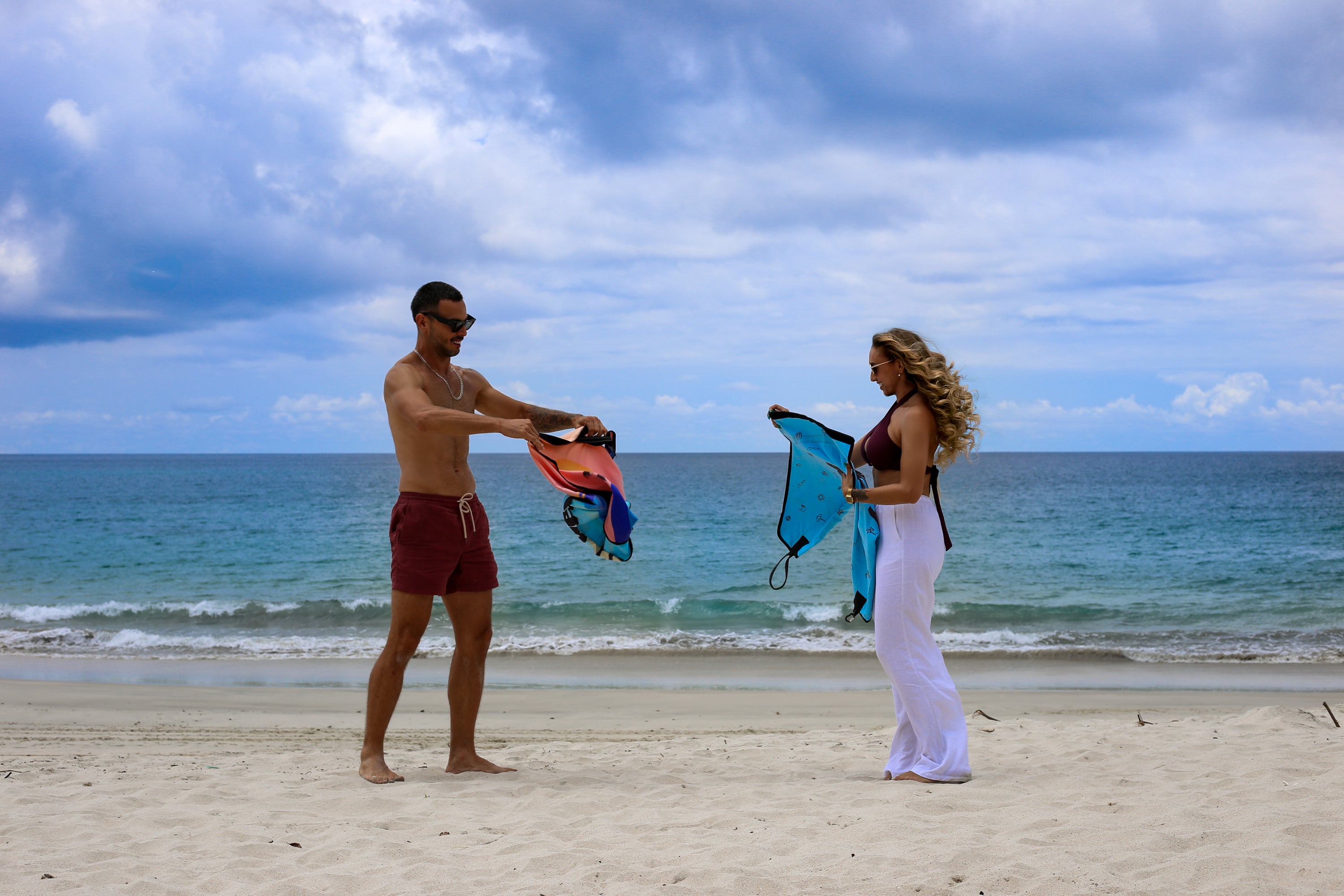 Couple unrolling Beach Leashes to prepare for use at the beach